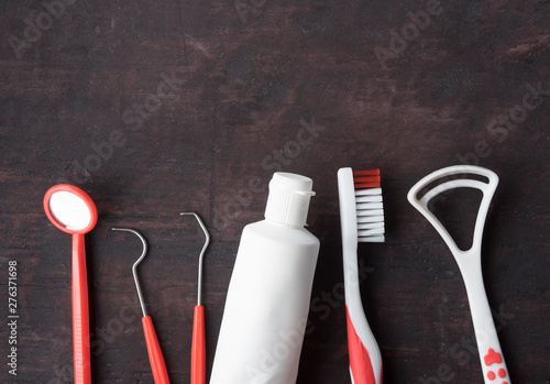 Set of different tools with toothbrushes and toothpaste tube on wood background,dental care