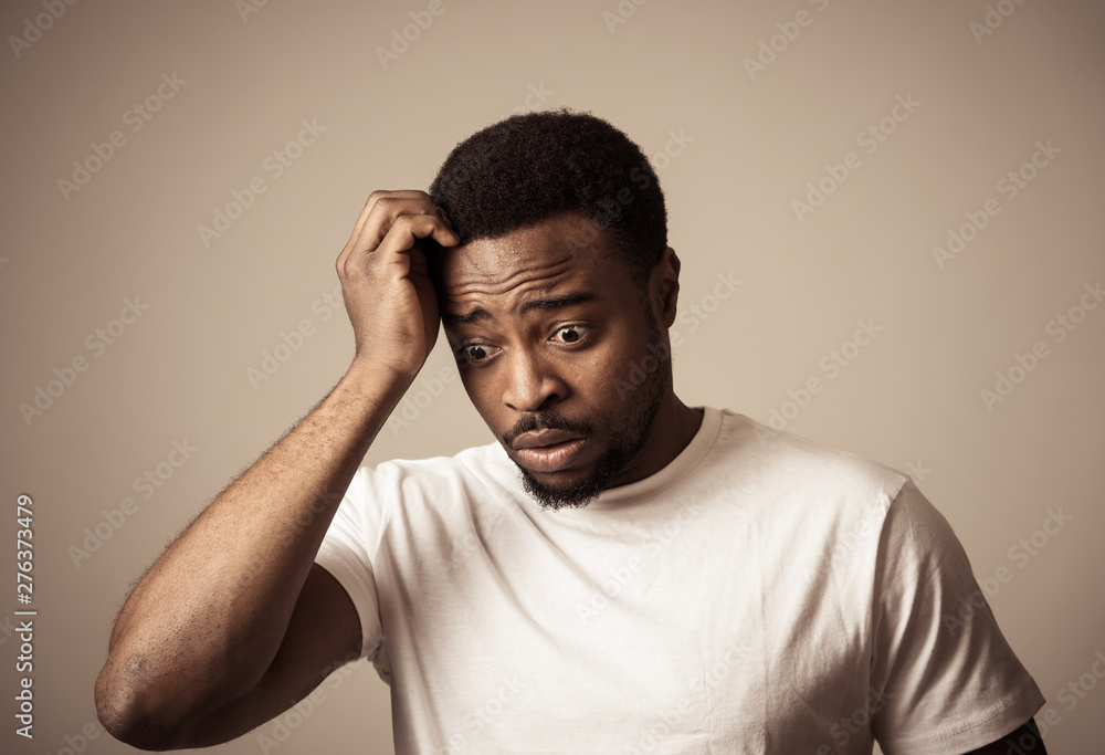 Close up portrait of Unhappy sad young man face suffering from depression and stress Close up portrait of Unhappy sad young man face suffering from depression and stress