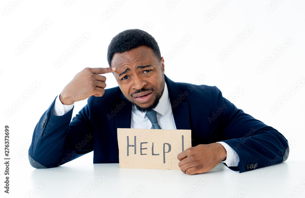 Young Businessman Holding Cardboard With Help Text At Workplace in stress and pressure at work. Young Businessman Holding Cardboard With Help Text At Workplace in stress and pressure at work.