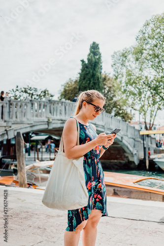 Young tourist woman using a smartphone in Venice. Italy