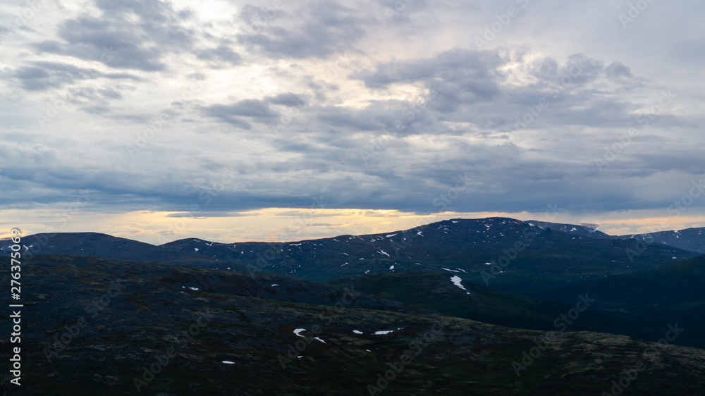 Rays of the setting sun over the mountain valley Khibiny