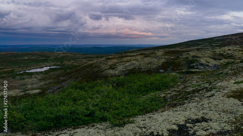 Rays of the setting sun over the mountain valley Khibiny