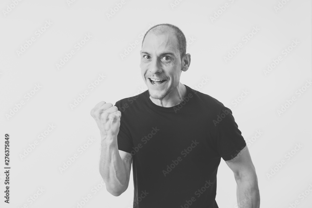 Facial expressions and emotions. Portrait of young man with crazy happy face celebrating victory Facial expressions and emotions. Portrait of young man with crazy happy face celebrating victory
