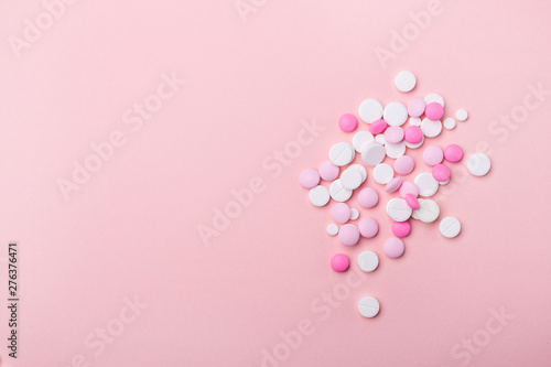 Pink and white pills on pink background Heap of assorted various medicine tablets and pills Health care Copy space Top view
