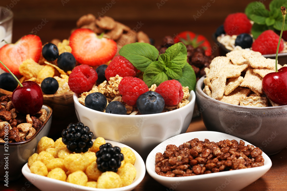 Cereal. Bowls of various cereals, berries and milk for breakfast. Muesli with kids cereals. Cereal. Bowls of various cereals, berries and milk for breakfast. Muesli with kids cereals.