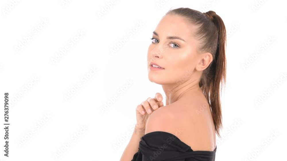Beauty concept. A charming woman is fondling her face on a white background. Beauty concept. A charming woman is fondling her face on a white background.