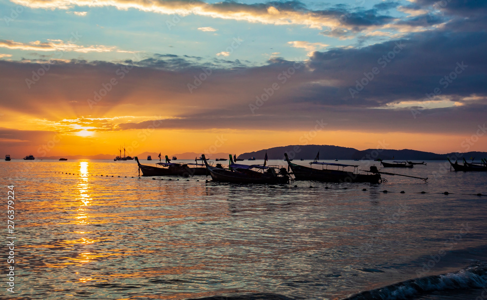 Longtail boats on seashore at sunset, Thailand