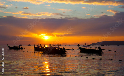 Longtail boats on seashore at sunset, Thailand © Mikael Damkier