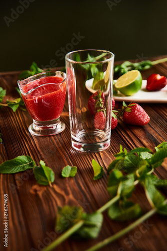 Wallpaper Mural cooking of cooling summer cocktail with strawberries, ice and mint and around the berries are ripe fresh strawberries and lime Torontodigital.ca