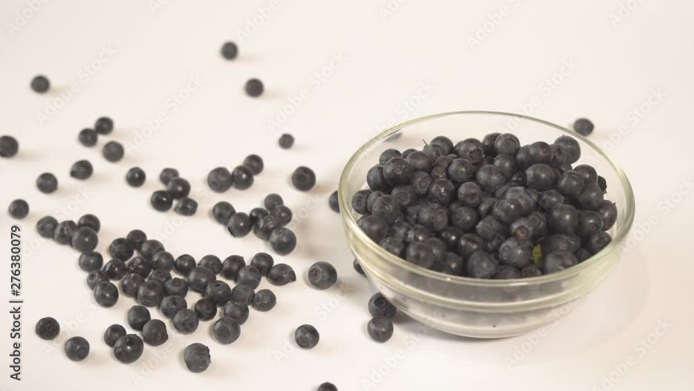 Blueberries scatter on a white table Blueberries scatter on a white table