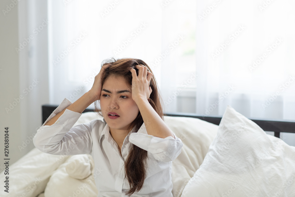 Young Asian woman shocked as she waking up late in morning, young girl laying in bed Young Asian woman shocked as she waking up late in morning, young girl laying in bed