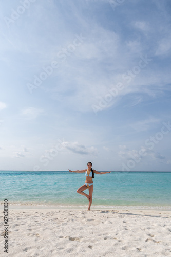 Meditation - Yoga woman meditating at serene beach.