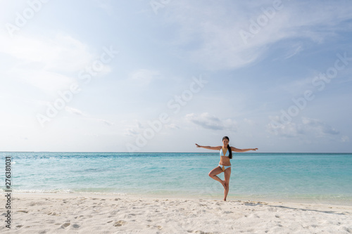 Meditation - Yoga woman meditating at serene beach.
