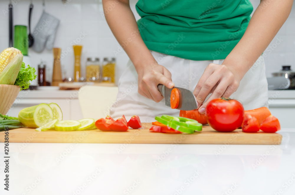 Diet. young pretty woman in green shirt cutting cooking and knife preparing fresh vegetables salad for good healthy in kitchen at home, healthy lifestyle, cooking, healthy food and dieting concept Diet. young pretty woman in green shirt cutting cooking and knife preparing fresh vegetables salad for good healthy in kitchen at home, healthy lifestyle, cooking, healthy food and dieting concept