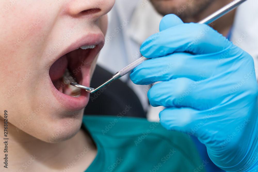dentist with the patient checking the dentures - obrazy, fototapety, plakaty 