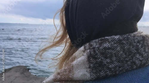 Girl has overcome her fear and goes to a cliff by the sea
