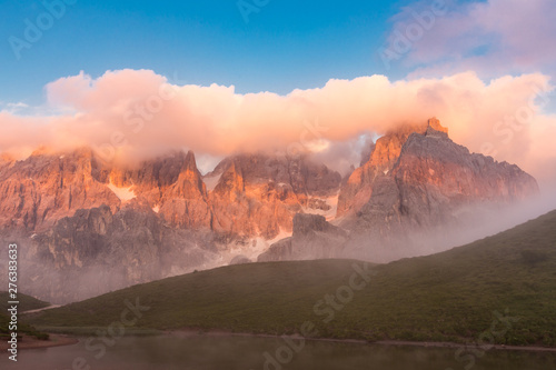 Sunset in Passo Rolle - Baita Segantini lake in Dolomite mountain range, Italy.