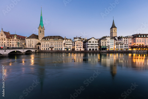 Beautiful view of Fraumunster Church and old town zurich by limmat river before sunrise