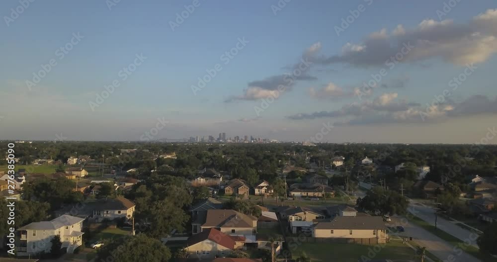 Fly up and tilt down camera over Bayou St. Johns most beautiful residences with New Orleans skyline in the distance Fly up and tilt down camera over Bayou St. Johns most beautiful residences with New Orleans skyline in the distance