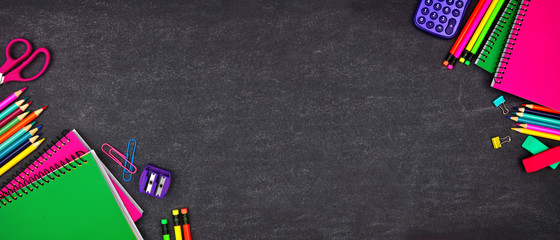 School supplies double corner border banner. Top view on a chalkboard background with copy space. Back to school concept.