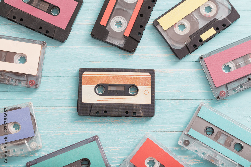 Fototapeta premium Old plastic cassette on wooden background. Retro music concept
