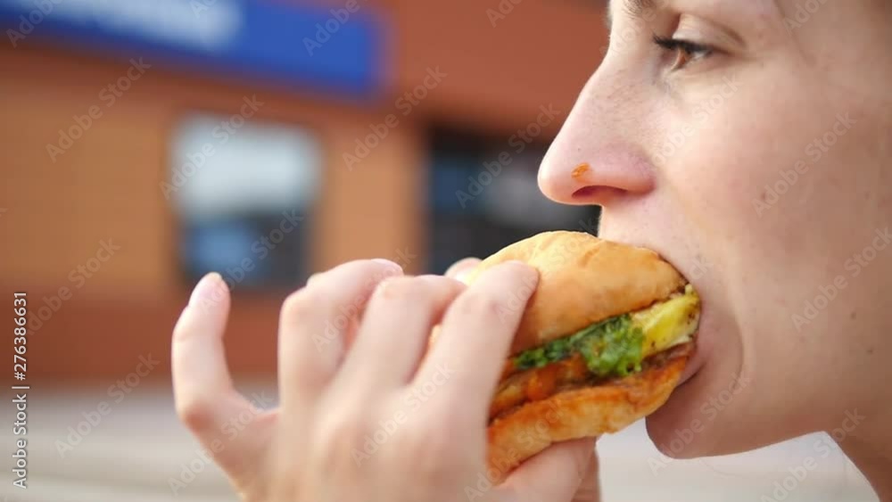 Closeup Of Woman Mouth Eating Vegan Burger. Closeup. Closeup Of Woman Mouth Eating Vegan Burger. Closeup.