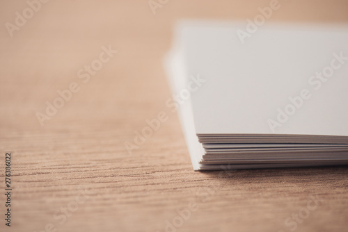 selective focus of white empty business cards on wooden surface
