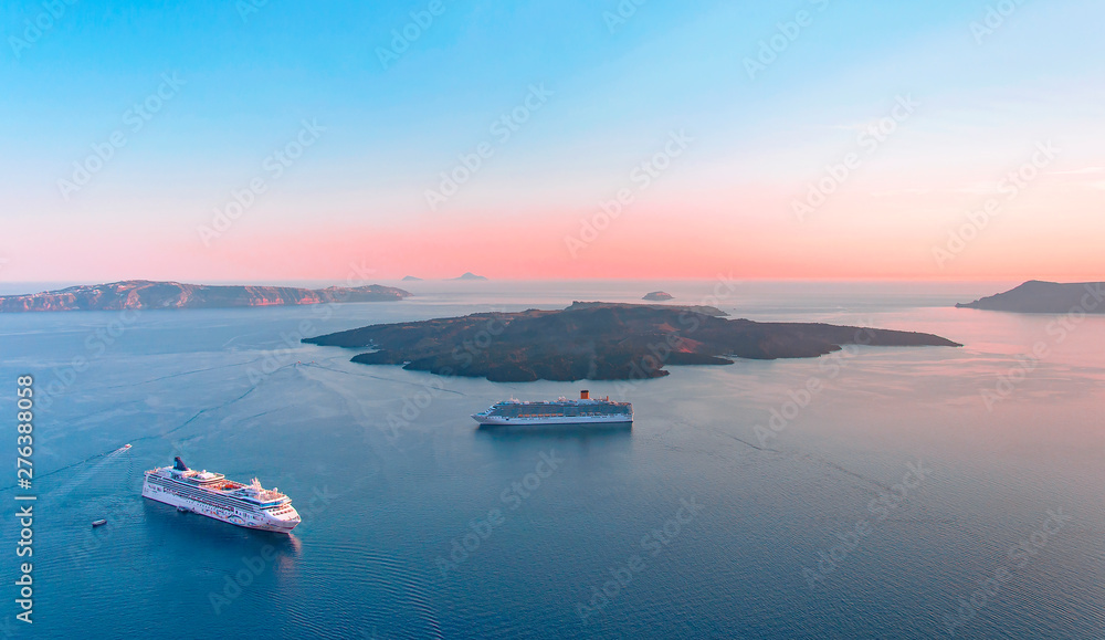 Beautiful landscape with sea view on the Sunset. Cruise liner in the Aegean Sea, Thira, Santorini island, Greece. Summer seascape overlooking the blue sea, caldera and volcano, travel concept