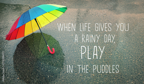 Konstfotografi when life gives you a rainy day, play in the puddles - inspiration quote on autumn abstract blurred defocused background