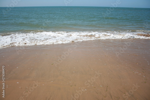 Spanish beach , water with waves at summer