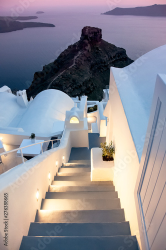 Beautiful evening sunset view of Greek architecture, stairs to the sea, view of the caldera. Santorini island, famous Greek resort Fira, Greece, Aegean sea, Europe. Traveling concept background