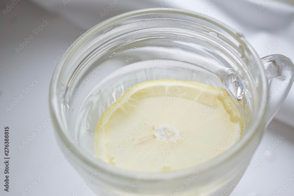 Transparent glass of lemonade with sliced lemon Transparent glass of lemonade with sliced lemon