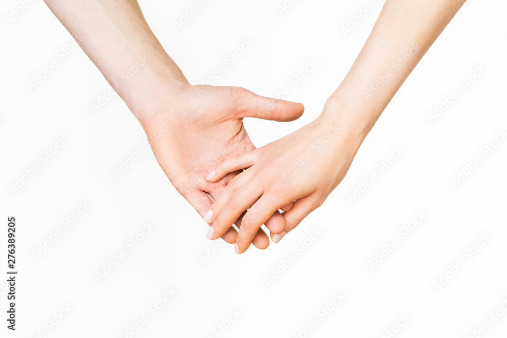 a man and a woman touch and hold hands on a light background. the concept of love and relationships