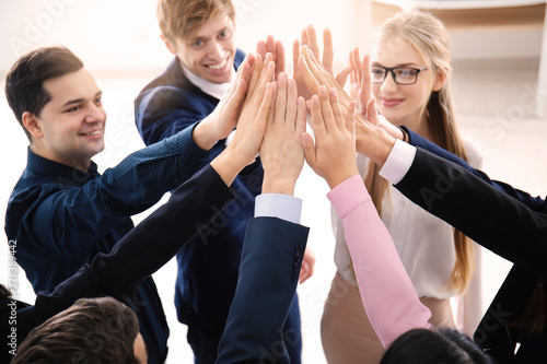 People putting hands togeth...