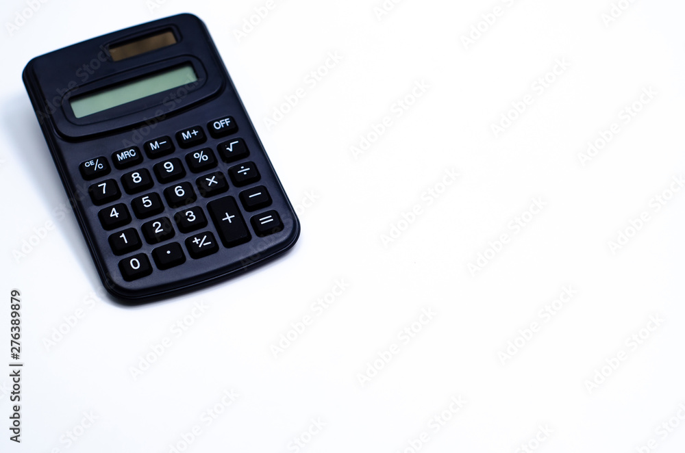 Black calculator placed isolated on a white background.Copy space. Black calculator placed isolated on a white background.Copy space.
