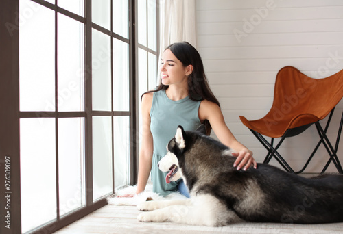 Young woman with cute Husky...