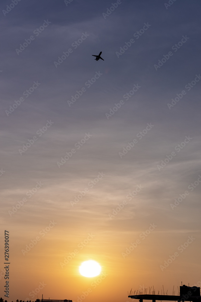 Fototapeta premium Airplane taking off or landing during sunset