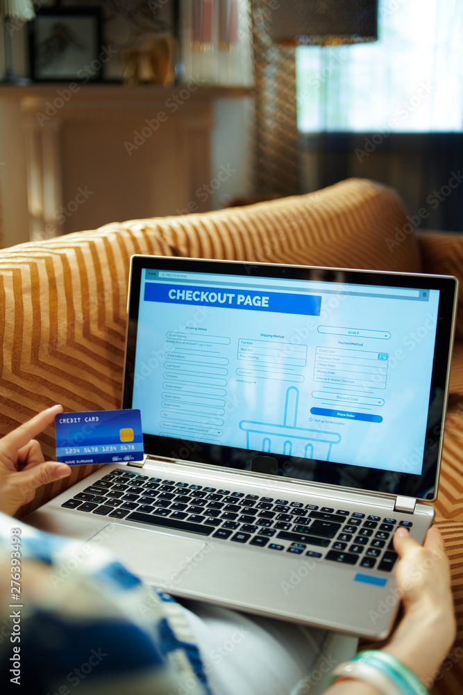 woman with credit card finishing online shop process on laptop woman with credit card finishing online shop process on laptop