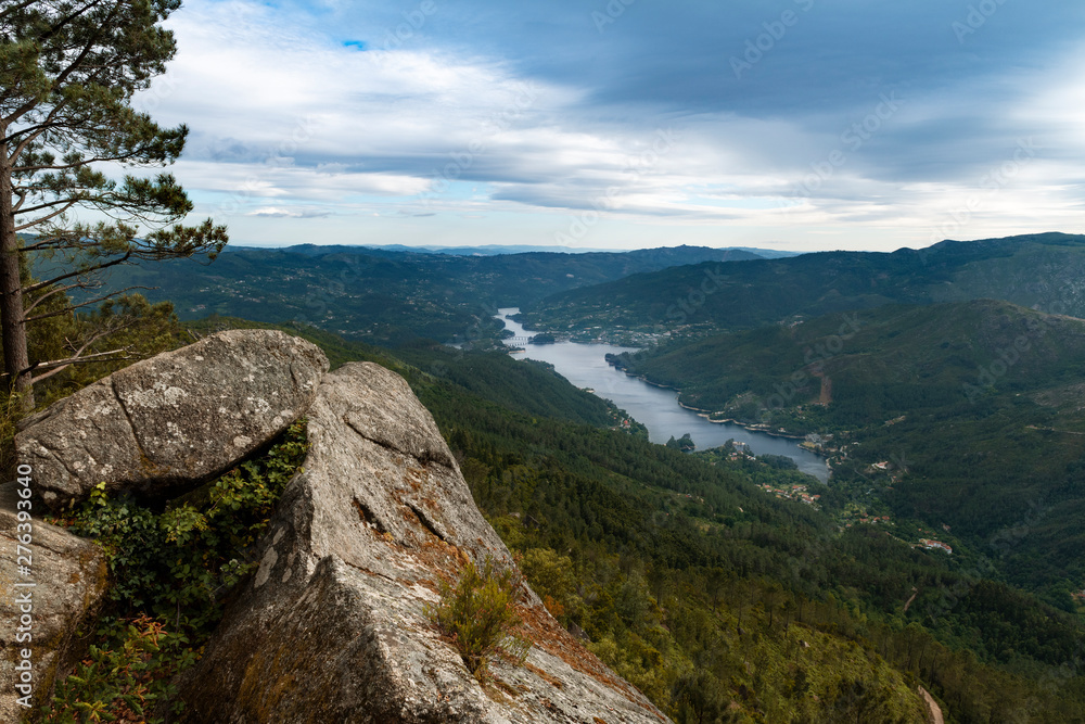 Scenic view of the lake at the Canicada Dam and the surrounding mountains from the Pedra Bela viewpoint at the Peneda Geres National Park, in Portugal, Europe. Scenic view of the lake at the Canicada Dam and the surrounding mountains from the Pedra Bela viewpoint at the Peneda Geres National Park, in Portugal, Europe.