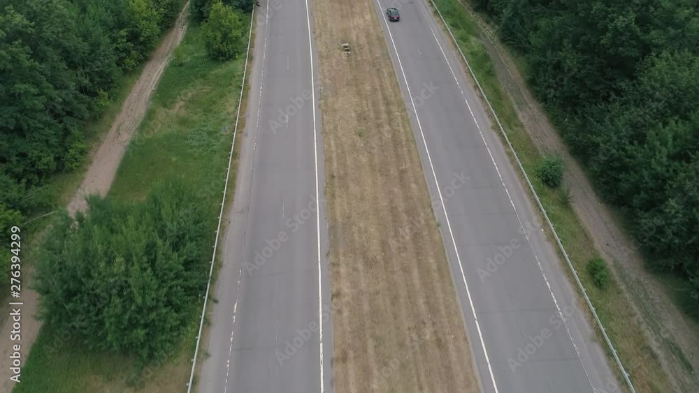 Highway in rural countryside. Aerial view on two way road and cars driving Highway in rural countryside. Aerial view on two way road and cars driving