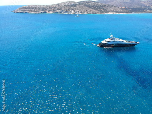 Aerial view of luxury private yacht in the blue sea during summer. Big yacht sailing in open waters. Santorini, Greece.  © Unwind
