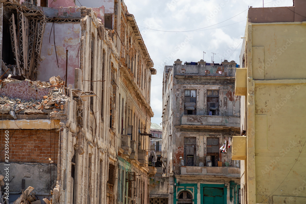 View of the broken and demolished residential homes in the Old Havana City, Capital of Cuba, during a cloudy and sunny day.