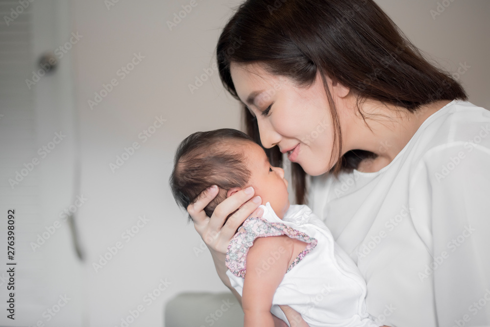 Beautiful woman holding a newborn baby in her arms Beautiful woman holding a newborn baby in her arms