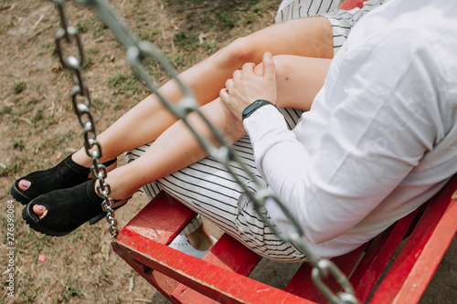 couple love sitting together hugging child swing