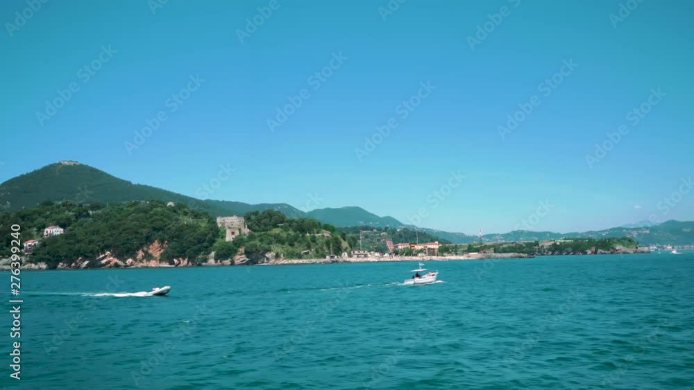View of the beautiful Italian Cinque Terre coastline from a moving boat on the Mediterranean sea View of the beautiful Italian Cinque Terre coastline from a moving boat on the Mediterranean sea