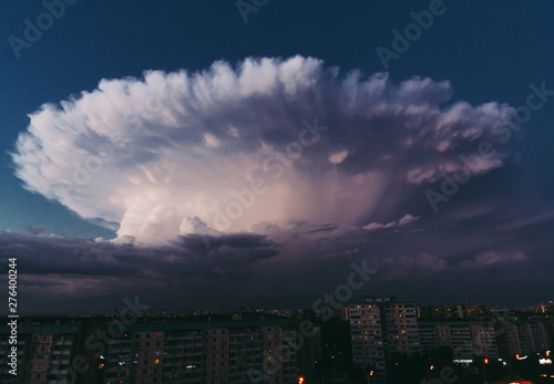 Thunderstorm over the city on a warm summer evening photo