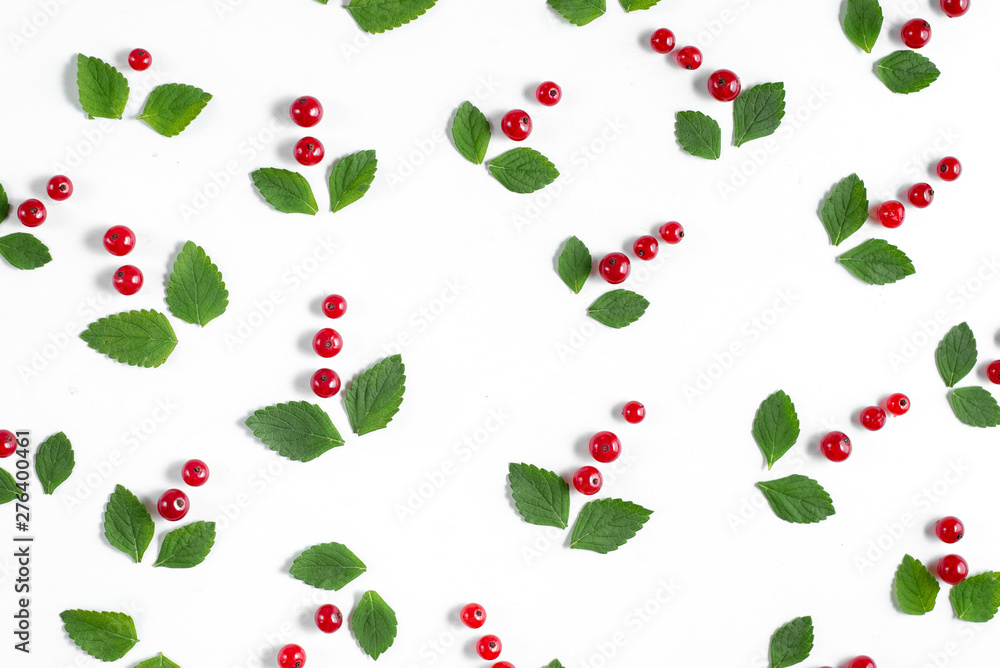 Green little leaves and fresh berries over white background separately. Concept of healthy food. Fruit pattern. Flat lay, top view, copy space Green little leaves and fresh berries over white background separately. Concept of healthy food. Fruit pattern. Flat lay, top view, copy space