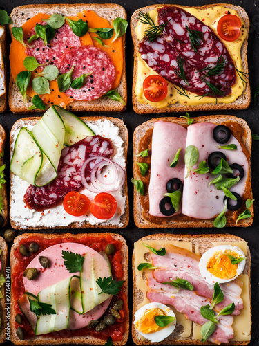 Set of eight different sandwiches with meat in square shape. Top view or flat lay. Assortment meat toasts on black background. Idea, creative concept for sausage maker