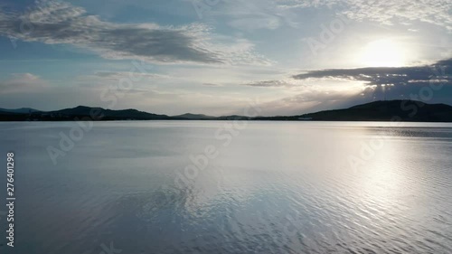 Wallpaper Mural Sunrise from the clouds.The Sun is rising from the mountain side.Camera flies over the lake near the water to the mountains.Early morning. Cloudy day.Type 3 Torontodigital.ca