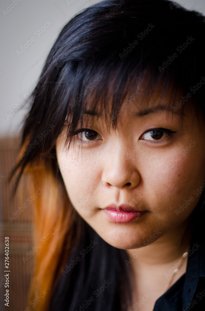 Close up young Asian woman with smiley face, short hair and a red strand Close up young Asian woman with smiley face, short hair and a red strand